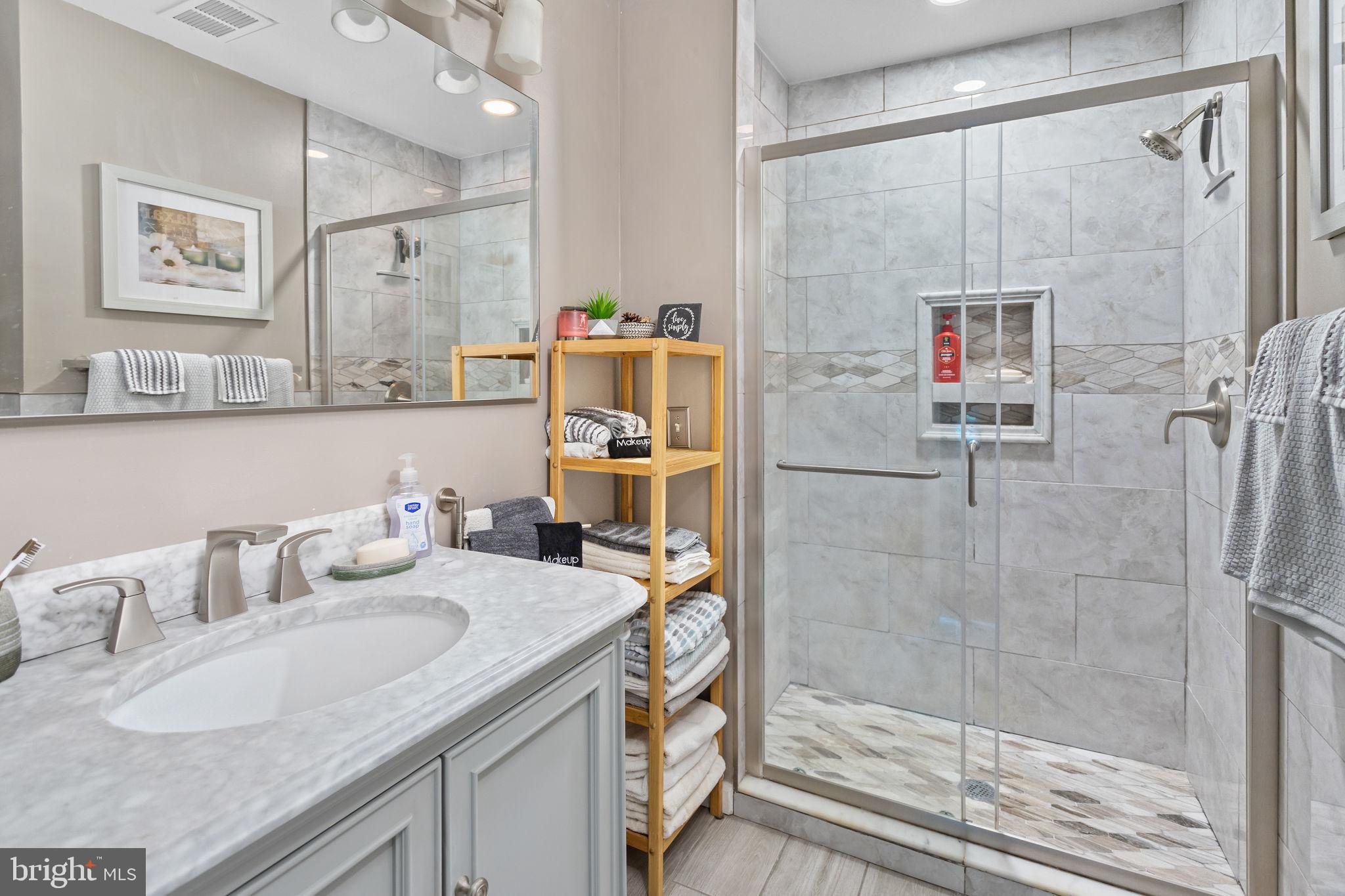 18 Geraldine Road East Windsor, NJ 08520 - Photo 26 of 42 a bathroom with a granite countertop shower sink and mirror