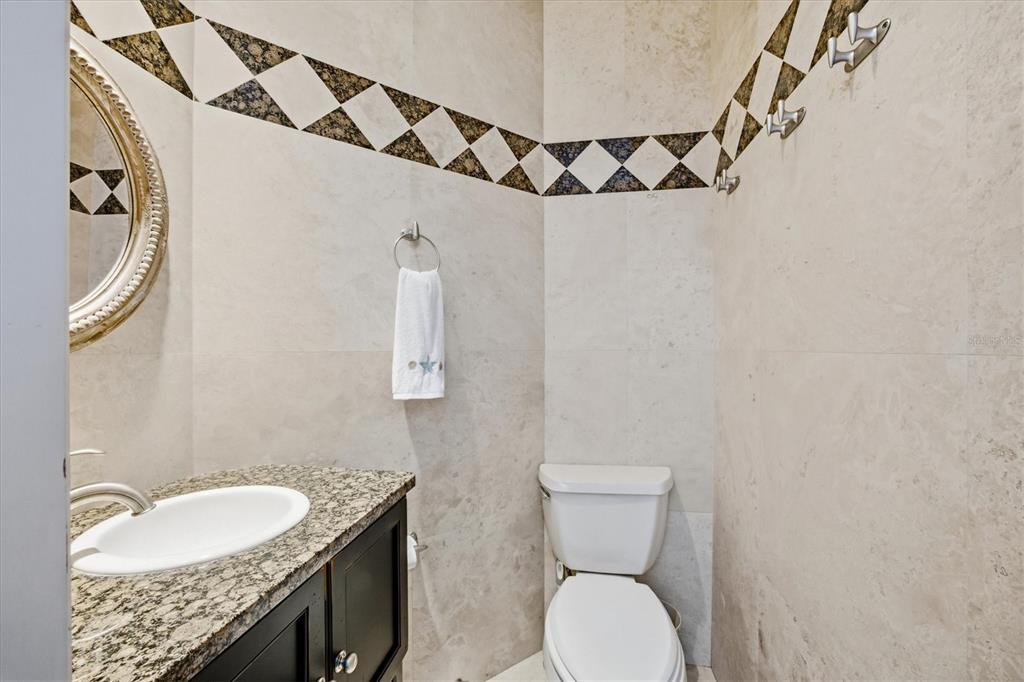 761 Norton Street Longboat Key, FL 34228 - Photo 50 of 66 a bathroom with a granite countertop sink and a mirror
