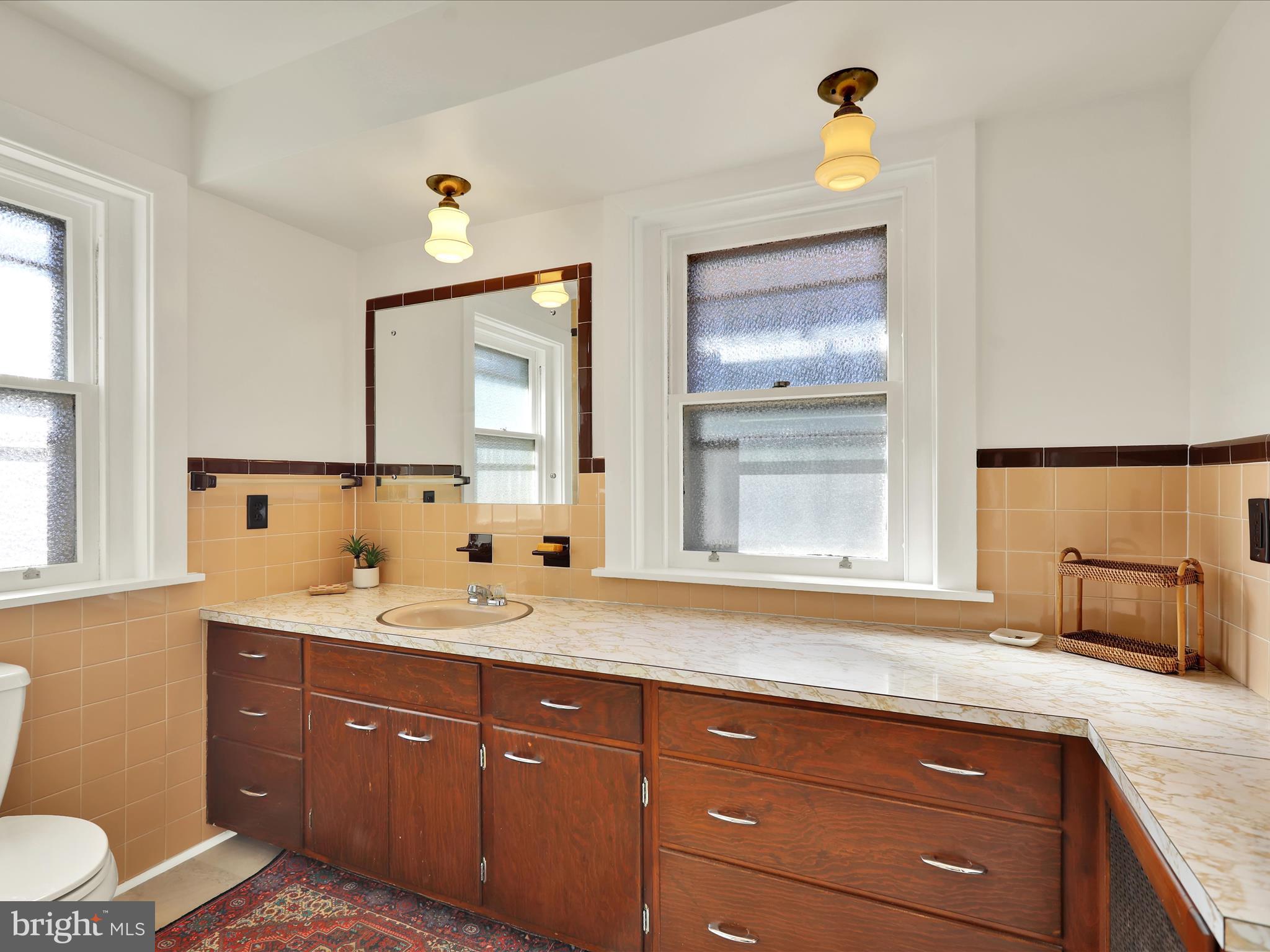 46 West Main Street Lebanon, PA 17042 - Photo 22 of 33 a bathroom with a granite countertop sink and a mirror