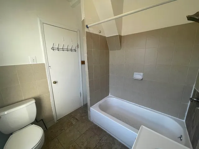 a bathroom with a toilet and shower