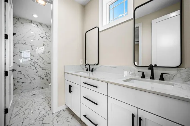 a bathroom with a double vanity sink and a mirror