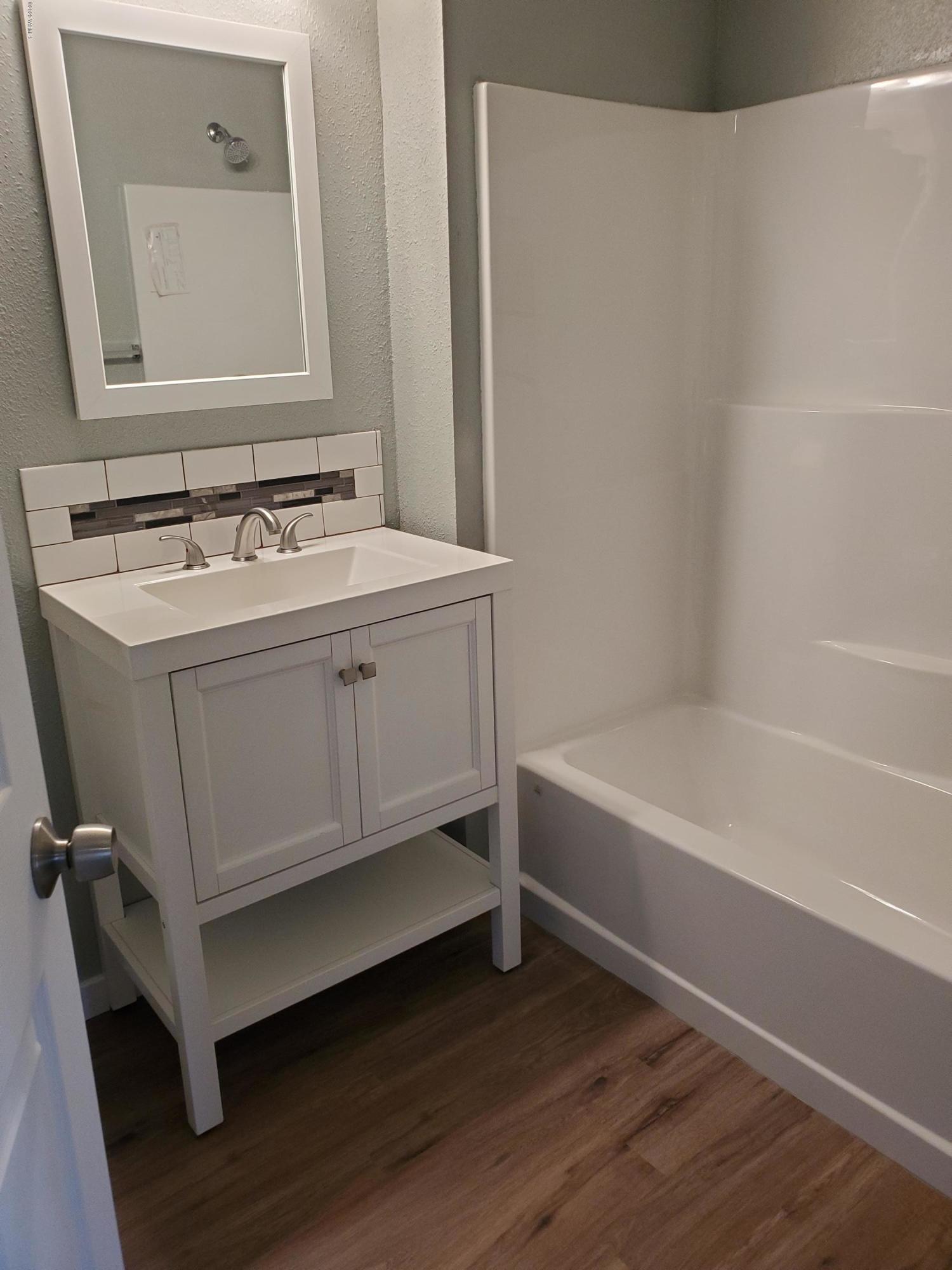 609 Bagley Road Granger, WA 98932 - Photo 9 of 11 a bathroom with a sink a mirror and a bathtub