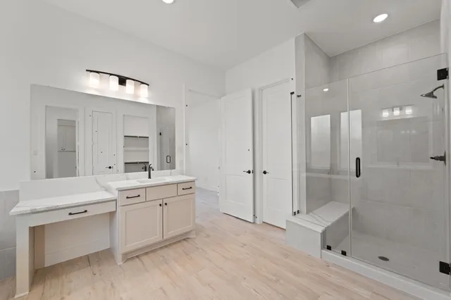 a spacious bathroom with a bathtub shower sink and mirror