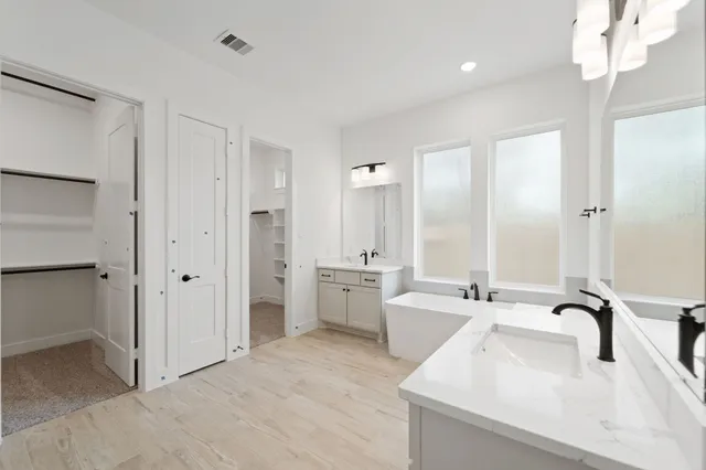 a bathroom with a double vanity sink mirror and shower