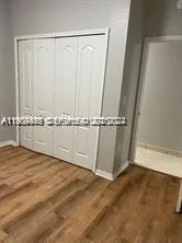 an empty room with wooden floor