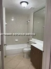 a bathroom with a granite countertop sink a toilet and a mirror
