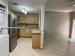 a kitchen with a refrigerator and a sink