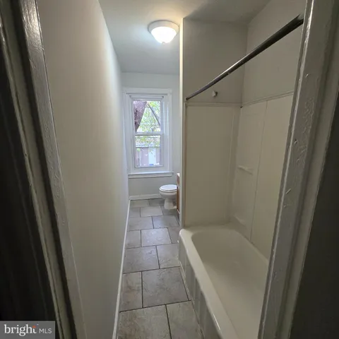 a bathroom with a tub a sink and a shower