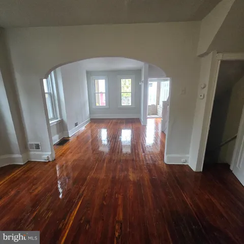 a view of livingroom with hardwood floor and front door