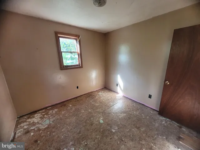 a view of a room with wooden floor and cabinet