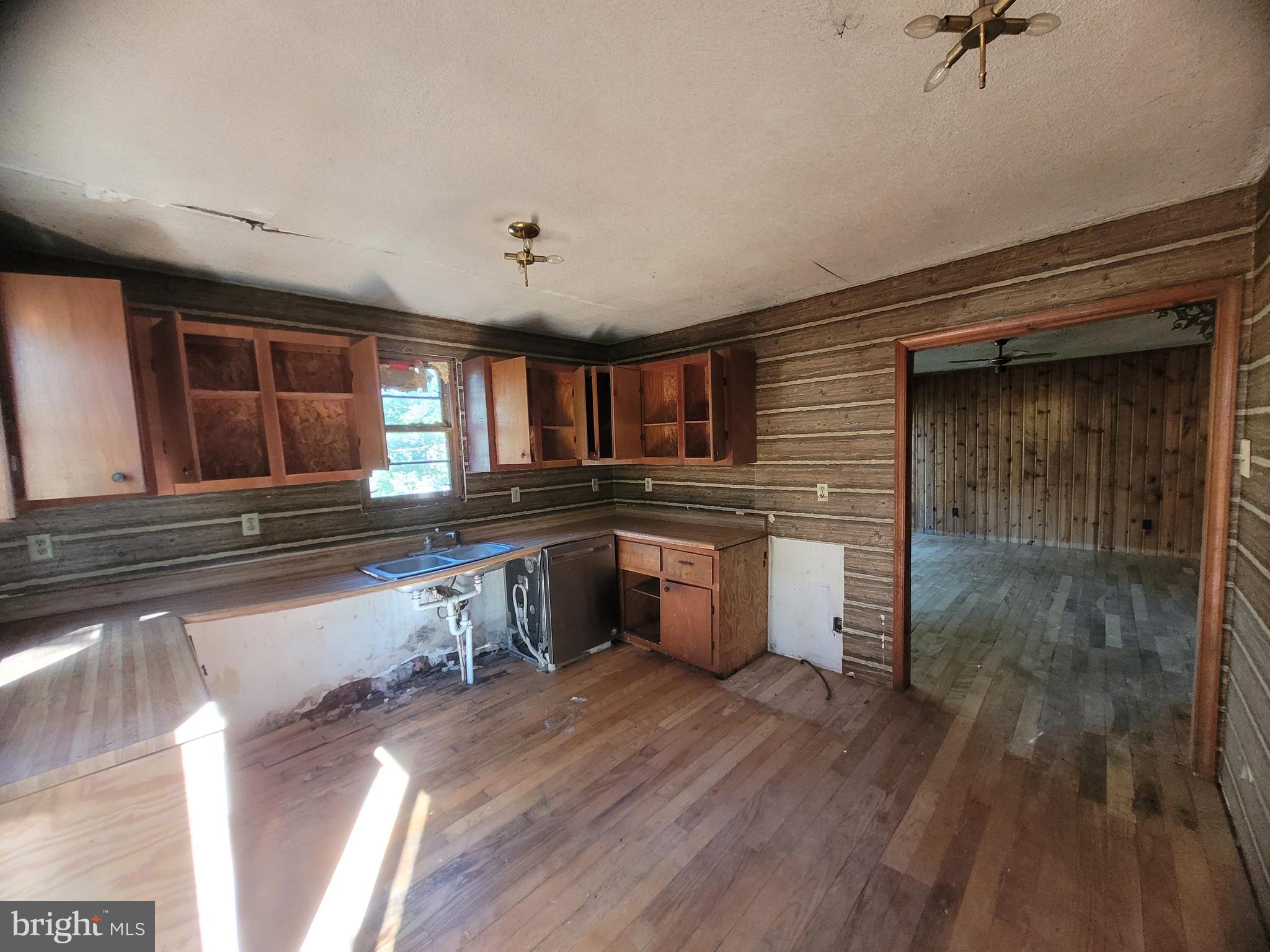 12700 Hockman Road Southeast Cumberland, MD 21502 - Photo 6 of 27 a kitchen with stainless steel appliances granite countertop a sink and wooden cabinets