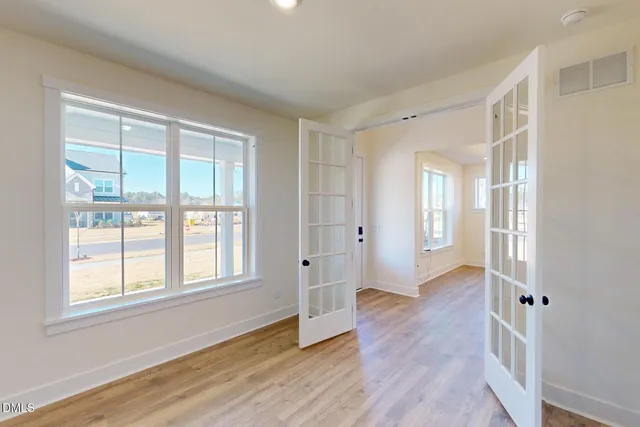 a view of a hallway with wooden floor and entryway