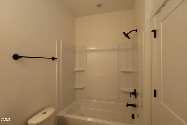 a bathroom with a shower sink and mirror