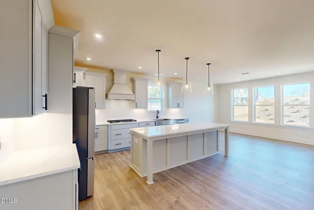 a kitchen with cabinets and window