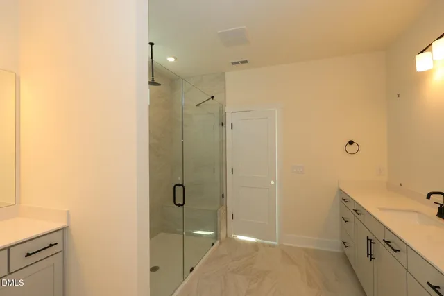 a view of an empty room with a fireplace and a window