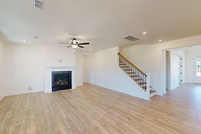 a view of open kitchen with wooden floor and electronic appliances