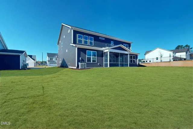a view of a house with a yard and tree s
