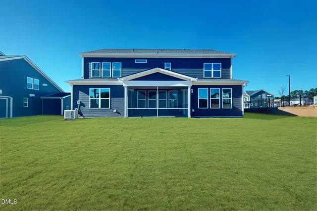 a view of a house with a yard and sitting area