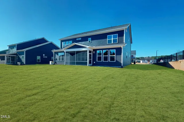a front view of a house with swimming pool having outdoor seating