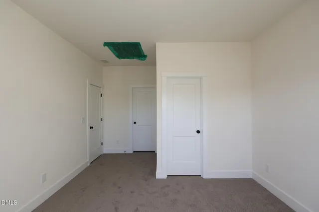 a bathroom with a granite countertop sink and a toilet