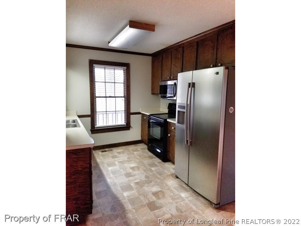 985 Line Road Cameron, NC 28326 - Photo 3 of 31 a kitchen with stainless steel appliances granite countertop a refrigerator a sink and dishwasher