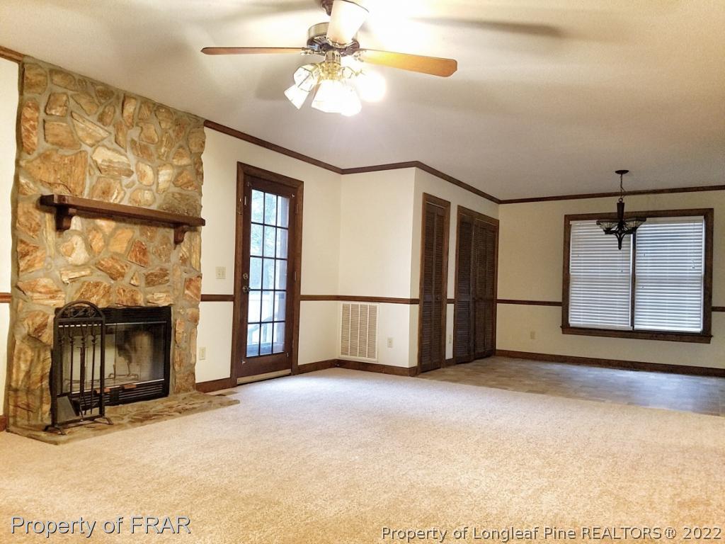 985 Line Road Cameron, NC 28326 - Photo 10 of 31 a view of an empty room with a fireplace and a window