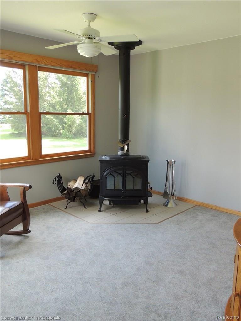 305 East Rattalee Lake Road Holly, MI 48442 - Photo 15 of 38 Dining Room with wood burning stove