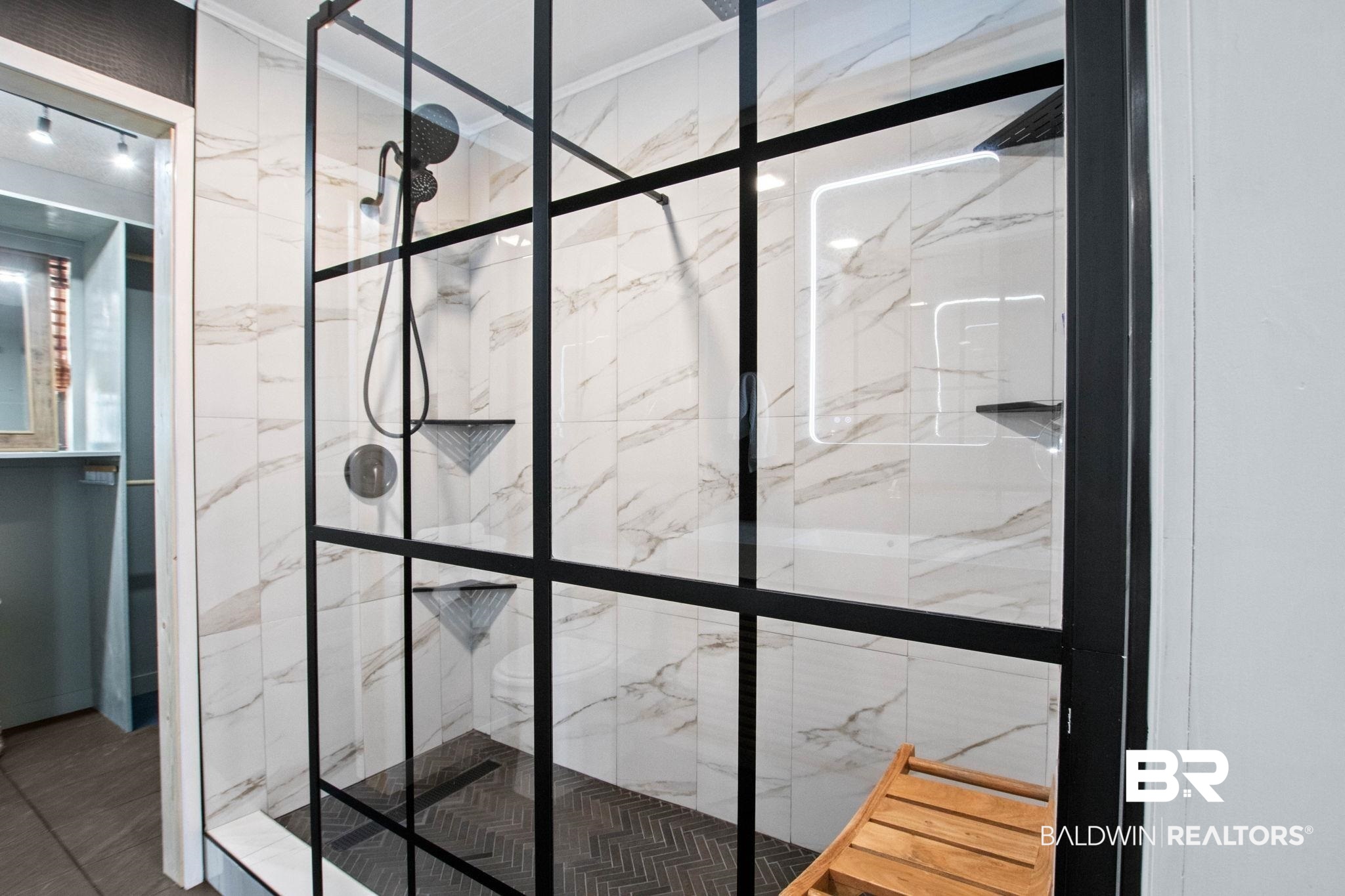 524 Ariel Avenue Foley, AL 36535 - Photo 19 of 37 Modern walk-in shower featuring a black-framed glass enclosure