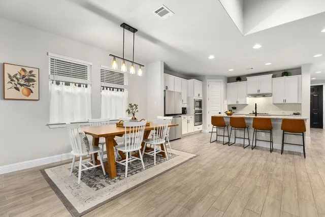 a view of a dining room with furniture window and wooden floor