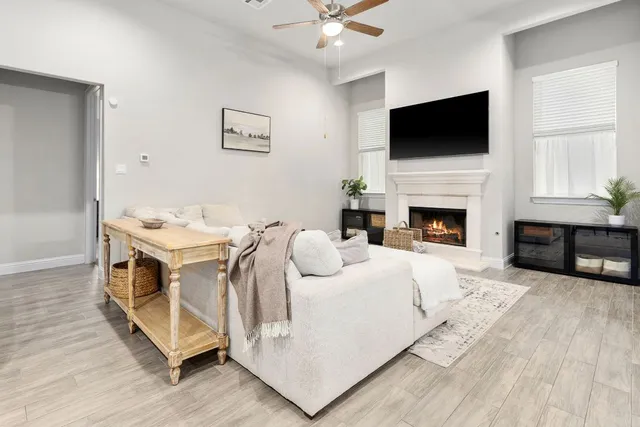 a living room with furniture fireplace and flat screen tv