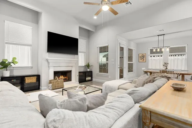 a living room with furniture fireplace and flat screen tv