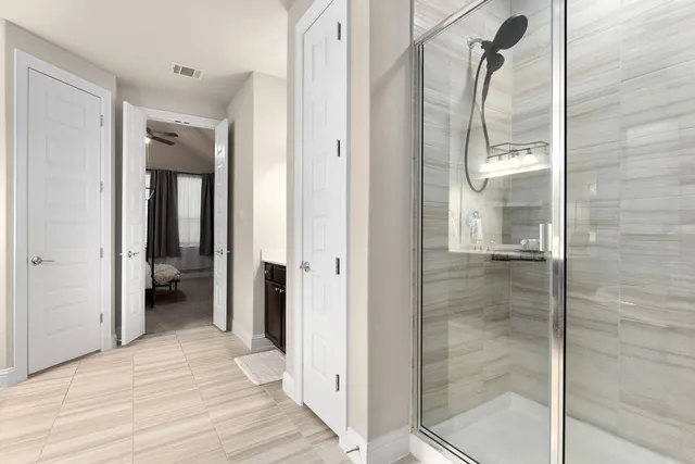 a bathroom with a shower and a mirror