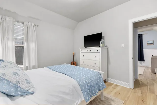 a bedroom with a bed and a flat screen tv