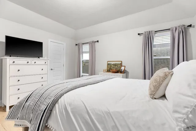 a bedroom with a bed and a flat screen tv