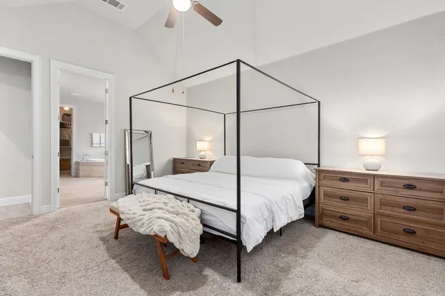 a bedroom with a bed lamp and a walk in closet