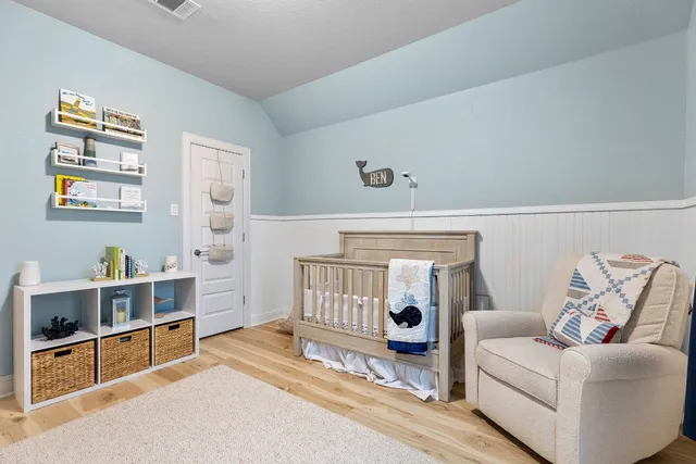 a living room with furniture and baby bed
