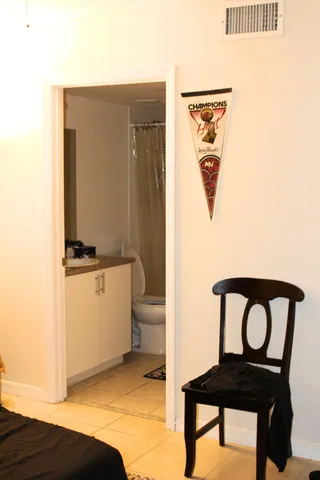 a bathroom with a toilet a sink and a mirror