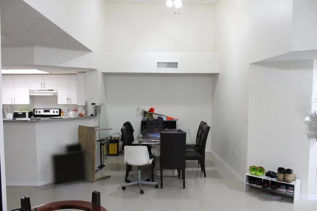 a dining room with furniture and a kitchen view