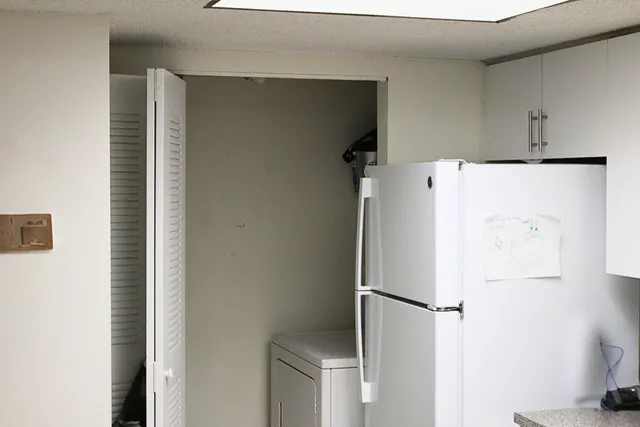 a white refrigerator freezer and a dishwasher sitting in a kitchen