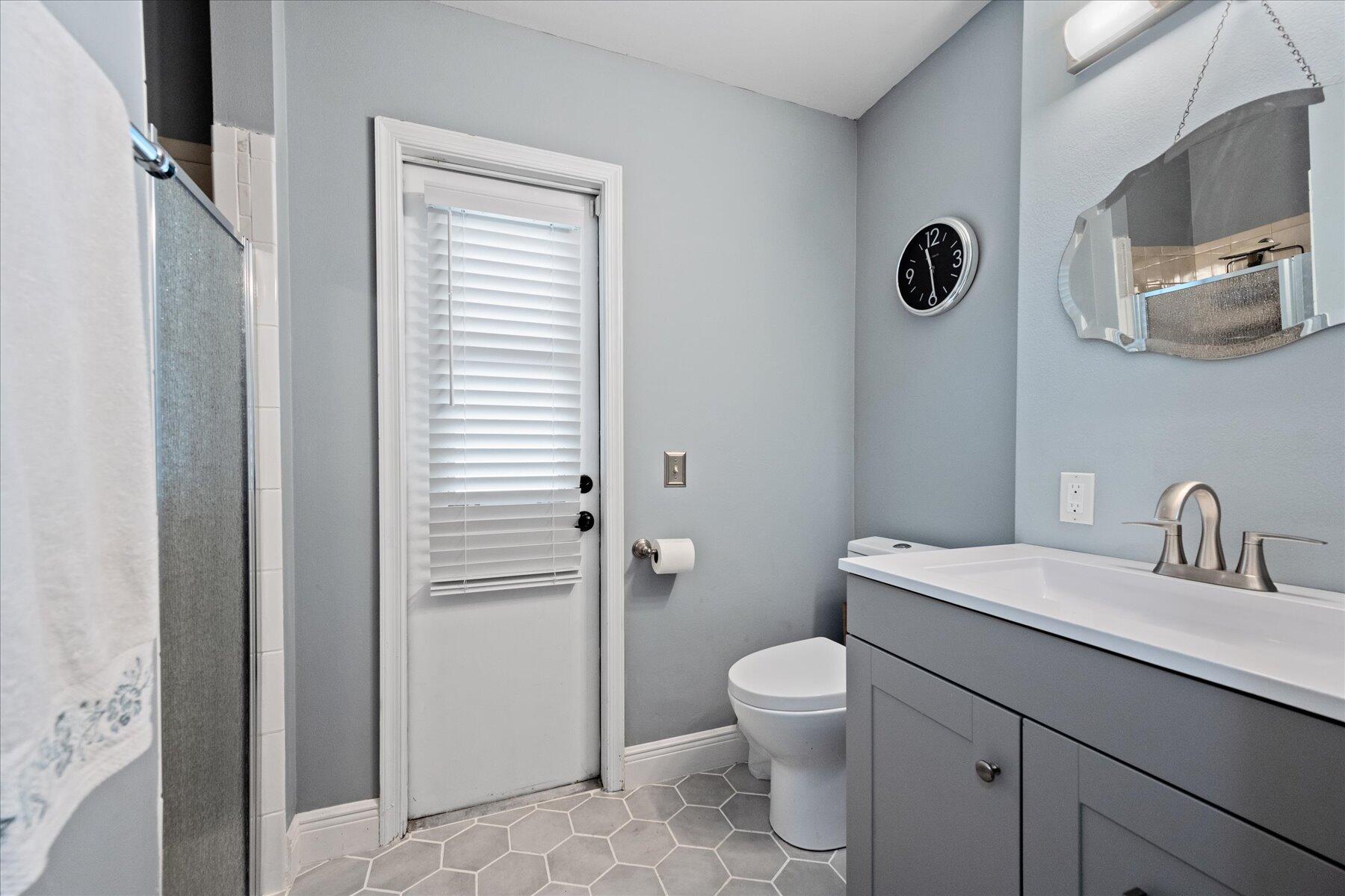 1373 Brampton Cove Wellington, FL 33414 - Photo 15 of 35 a bathroom with a toilet a sink and mirror