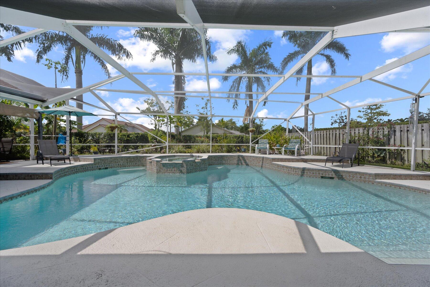 1373 Brampton Cove Wellington, FL 33414 - Photo 23 of 35 a view of a swimming pool with a patio