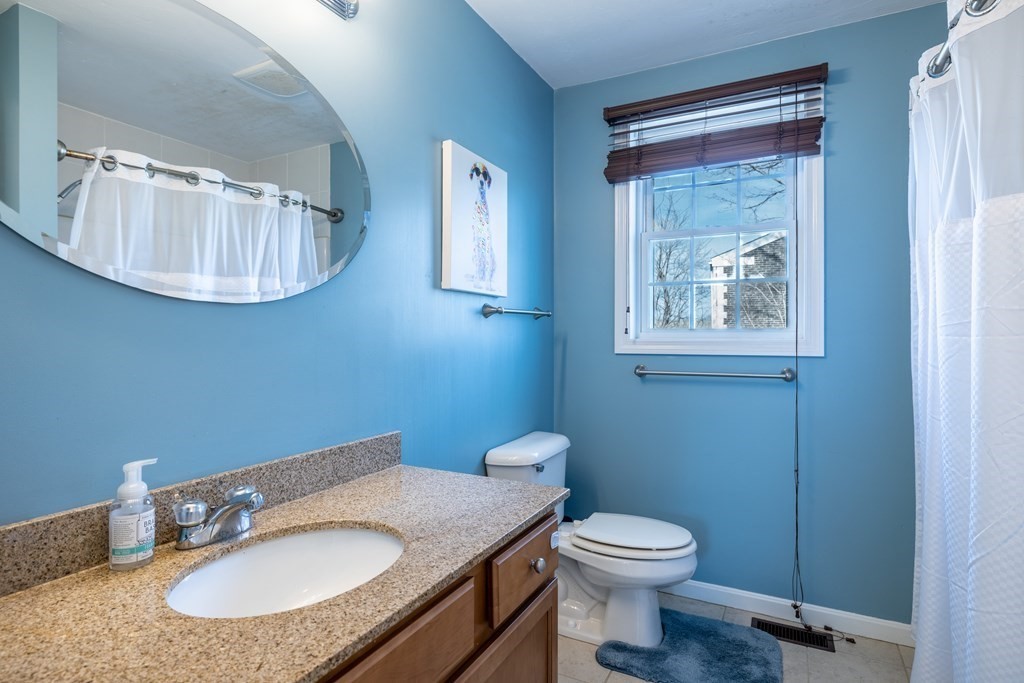 90 Central Street, Unit 2 East Bridgewater, MA 02333 - Photo 13 of 26 a bathroom with a granite countertop sink toilet a mirror and vanity