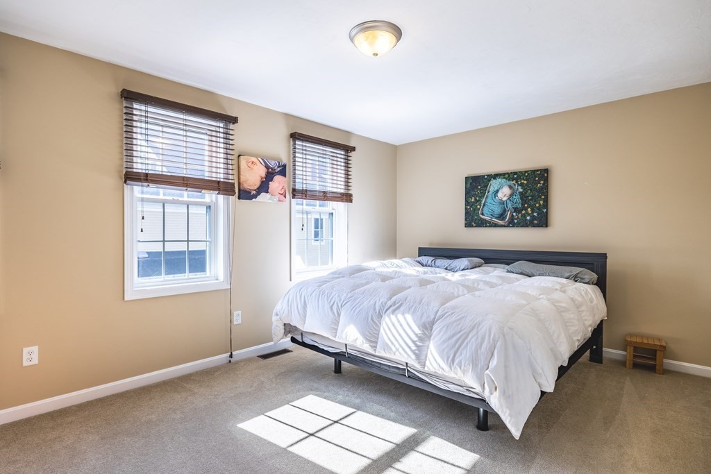 90 Central Street, Unit 2 East Bridgewater, MA 02333 - Photo 14 of 26 a bed sitting in a bedroom next to a window