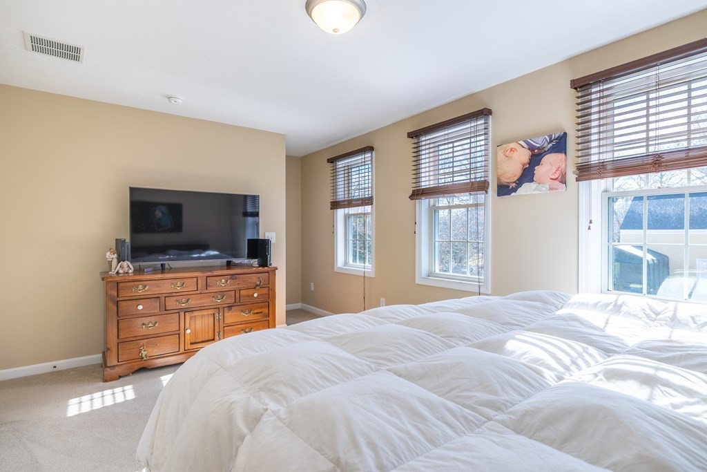 90 Central Street, Unit 2 East Bridgewater, MA 02333 - Photo 15 of 26 a bedroom with a bed and flat screen tv