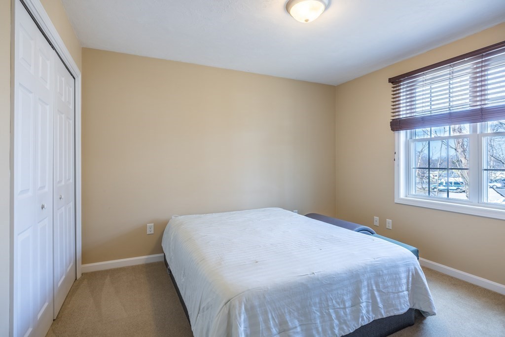 90 Central Street, Unit 2 East Bridgewater, MA 02333 - Photo 18 of 26 a bed sitting in a bedroom next to a window