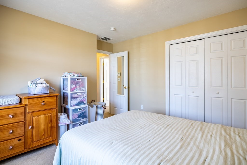 90 Central Street, Unit 2 East Bridgewater, MA 02333 - Photo 19 of 26 a bedroom with a bed and wooden floor