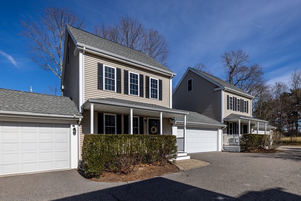 90 Central Street, Unit 2 East Bridgewater, MA 02333 - Photo 4 of 26 a front view of a house with a yard