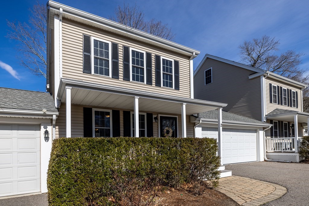 90 Central Street, Unit 2 East Bridgewater, MA 02333 - Photo 5 of 26 a front view of a building with a garden