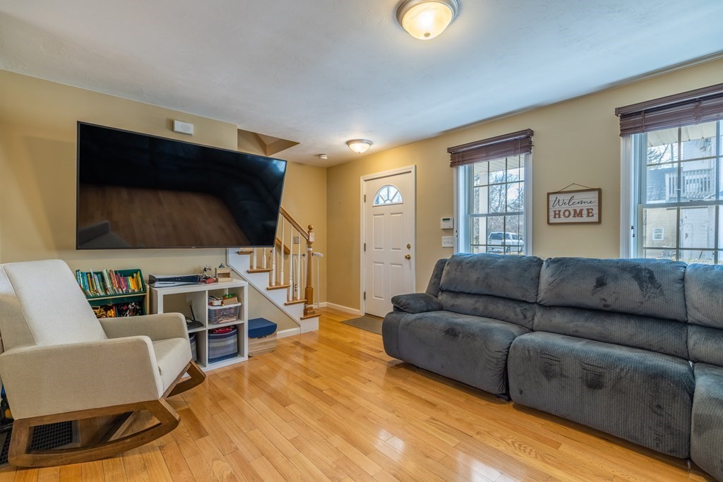 90 Central Street, Unit 2 East Bridgewater, MA 02333 - Photo 7 of 26 a living room with furniture and a flat screen tv