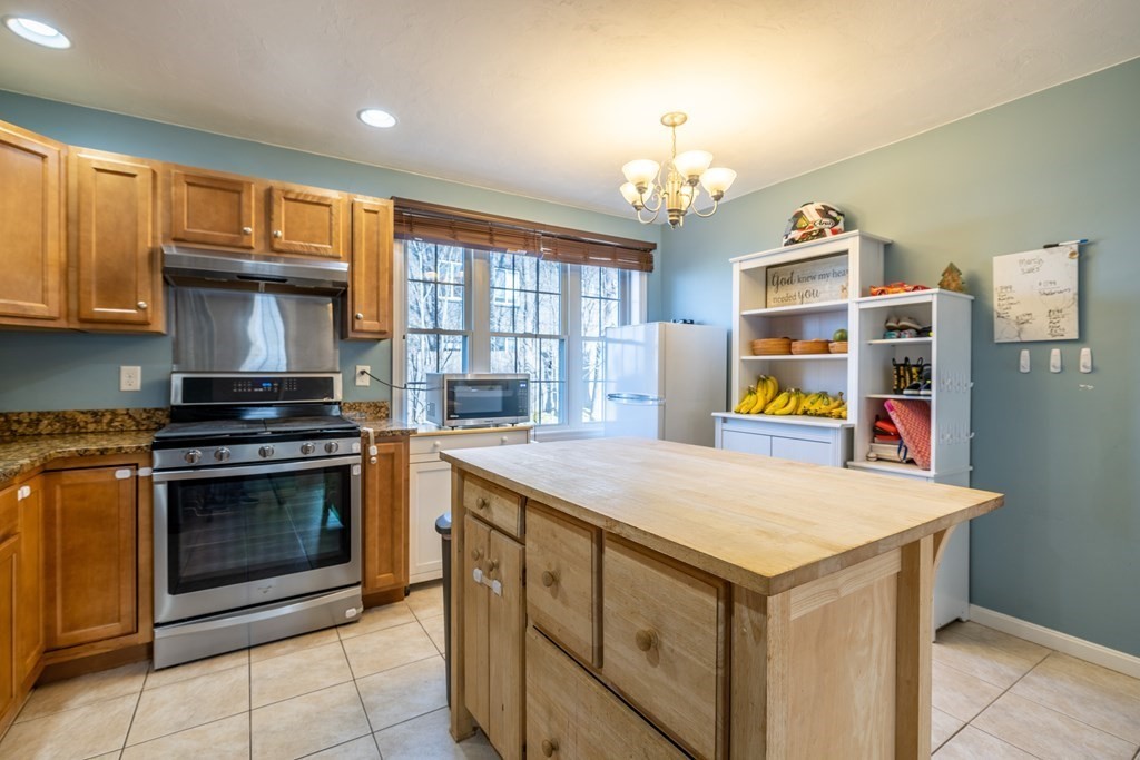 90 Central Street, Unit 2 East Bridgewater, MA 02333 - Photo 10 of 26 a kitchen that has a stove and a table